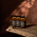 Three jars of ‘True Collagen' on a wooden surface with a warm brown background
